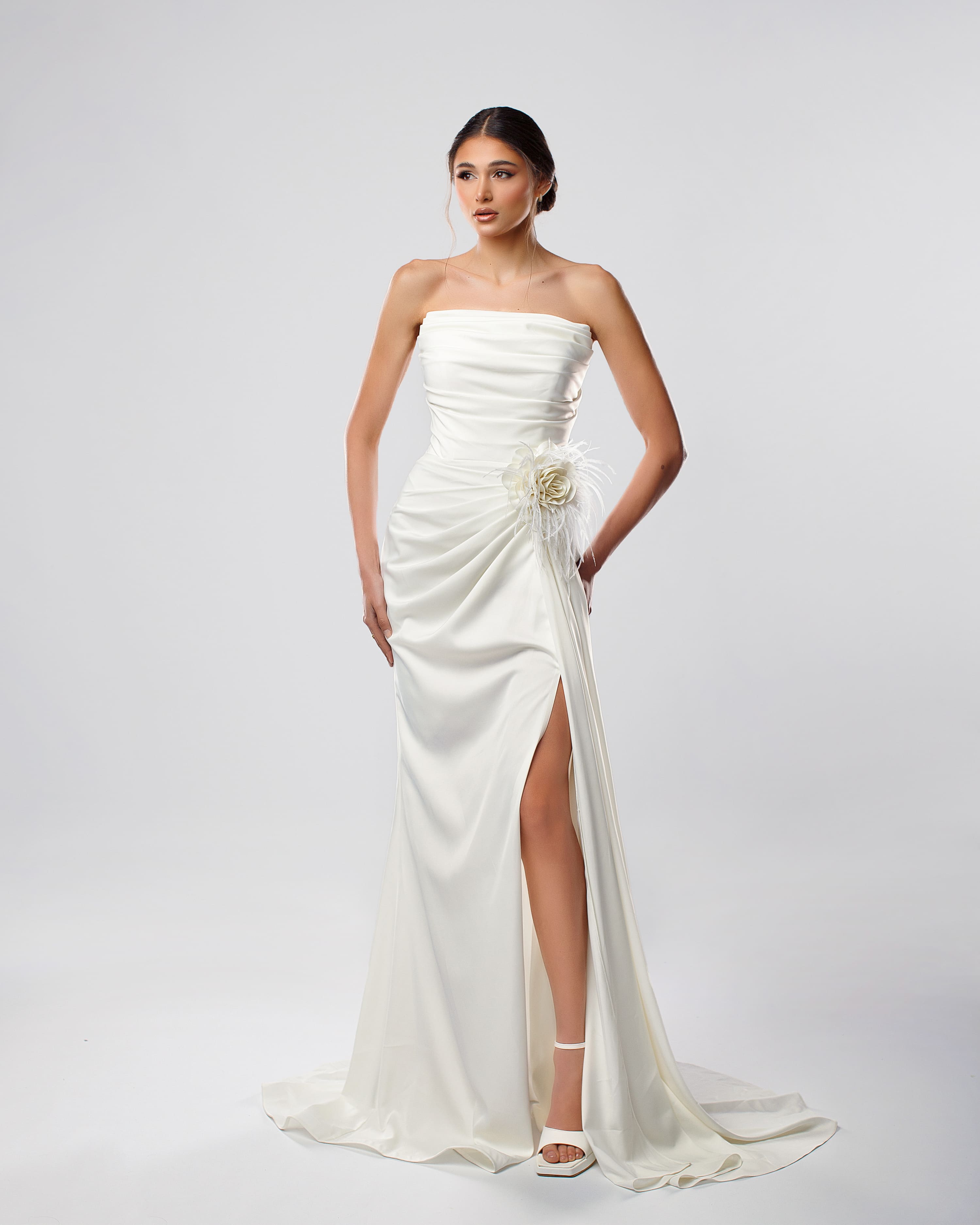 Strapless white bridal long dress with thigh-high slit and feather flower accent - Side view